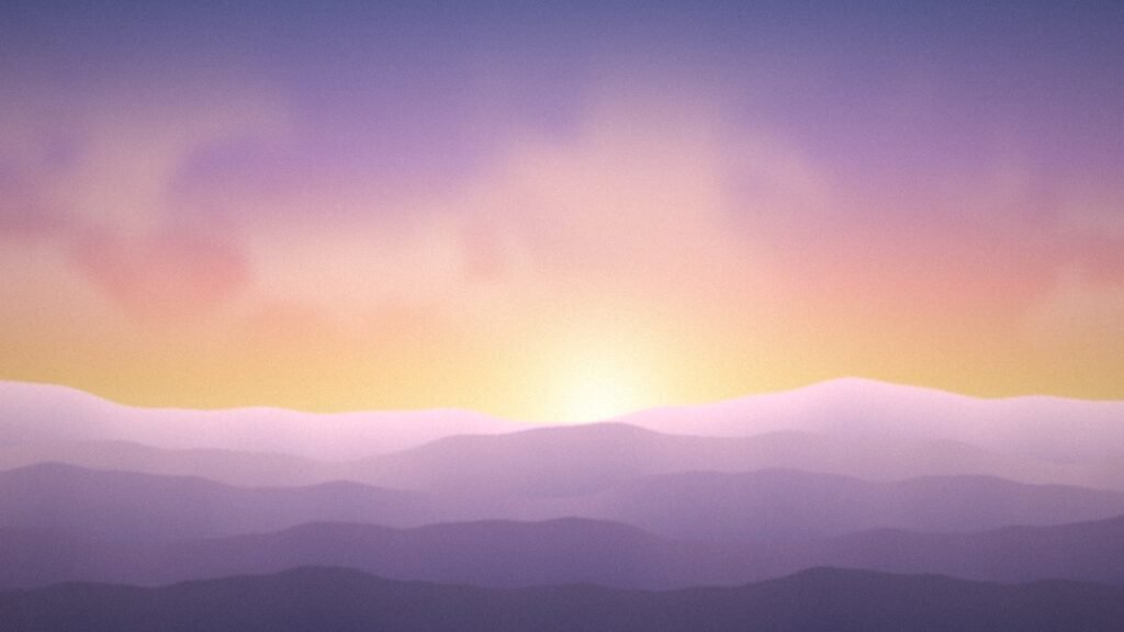 Soft pink and gold sunrise glowing behind layered misty hills