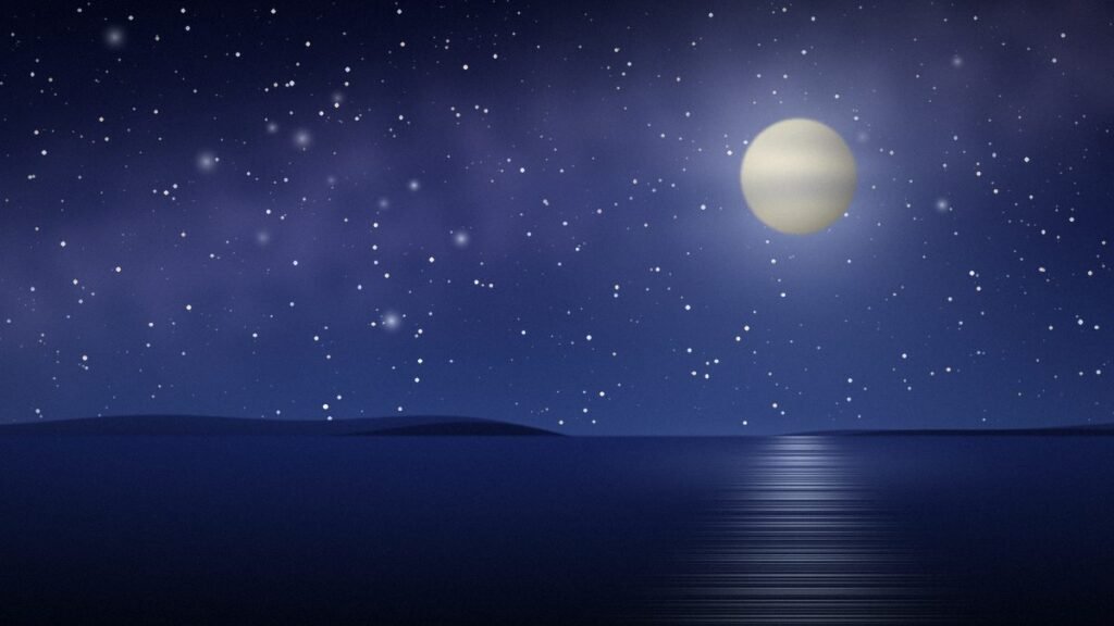 Full moon over still water under a starry indigo night sky